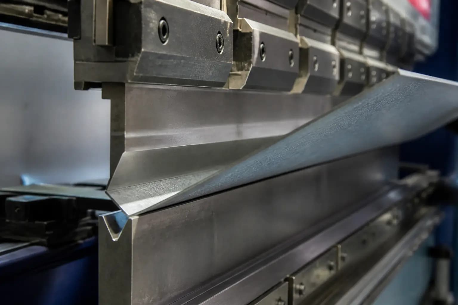Sheet metal press brake forming a steel panel
